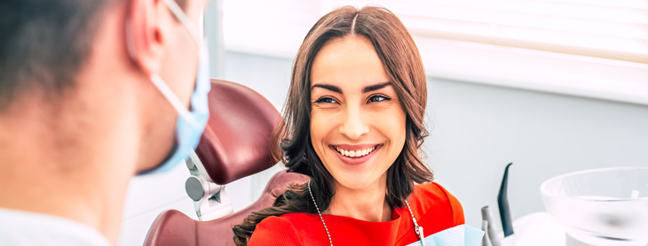 Woman smiling up at her dentist