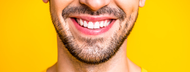 Closeup of man smiling with gleaming white teeth