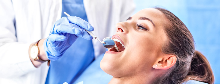 Dentist checking a woman's teeth